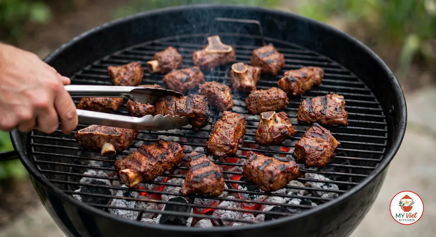 Turning spice-rubbed goat meat pieces, some bone-in, with steel tongs on a charcoal grill over glowing, ash-covered coals